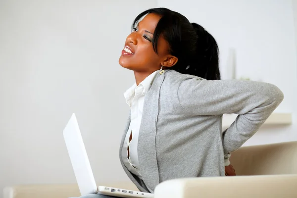 Afro-american young woman with back pain — Stock Photo, Image