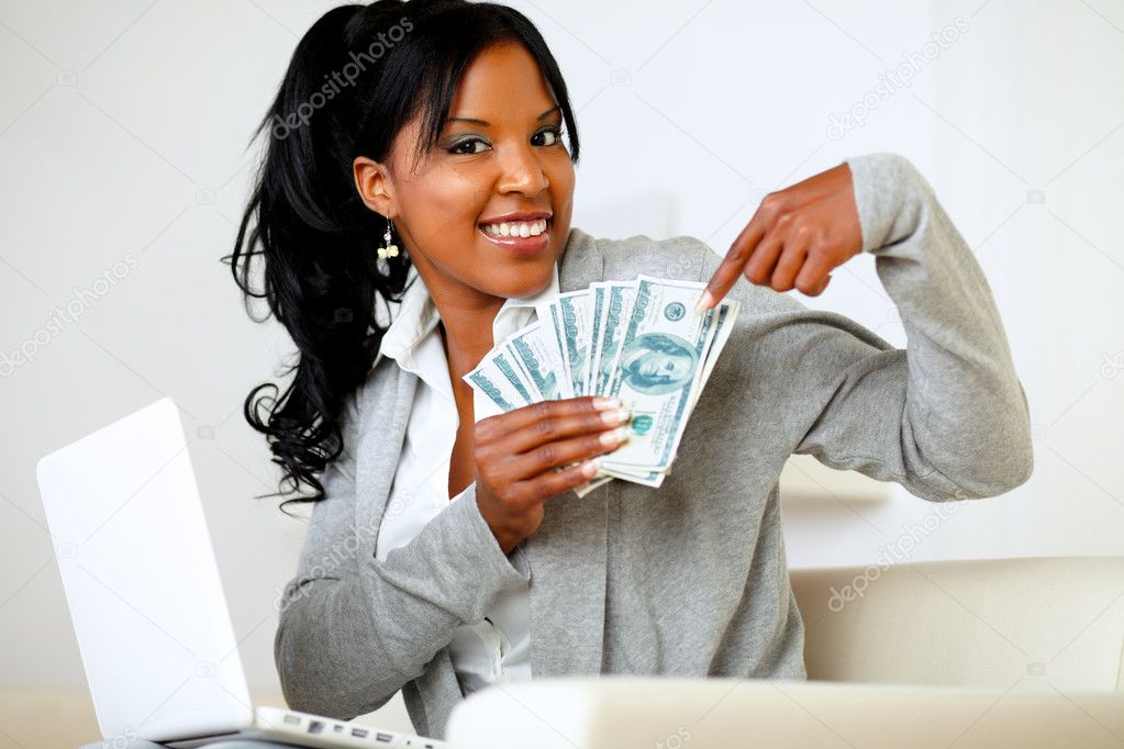 Happy woman pointing plenty of cash money