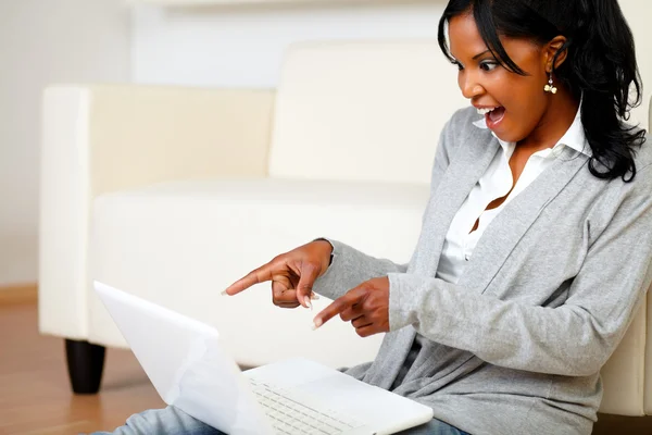 Возбужденная стильная женщина, указывающая на экран ноутбука — стоковое фото