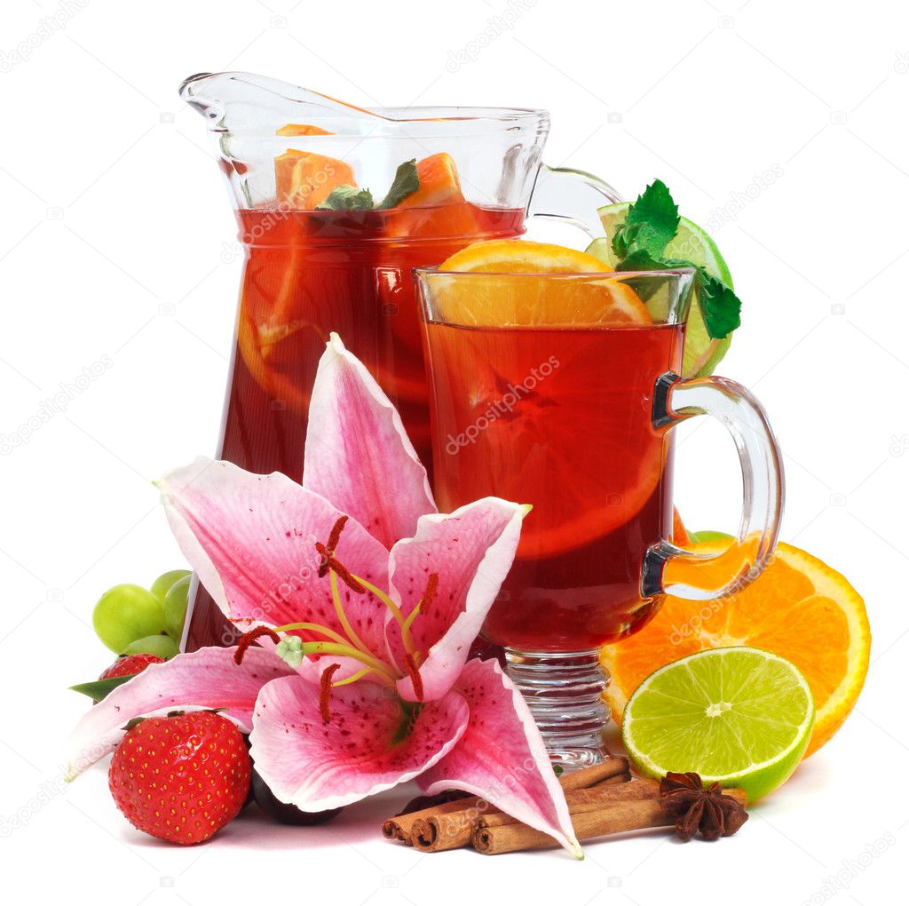 Refreshment beverage in pitcher and glass with fruits and spice