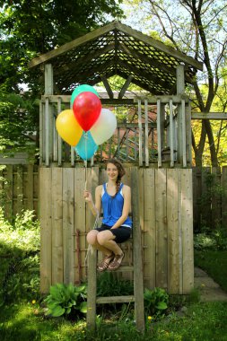 Teen holding baloons