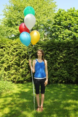 Teen holding baloons