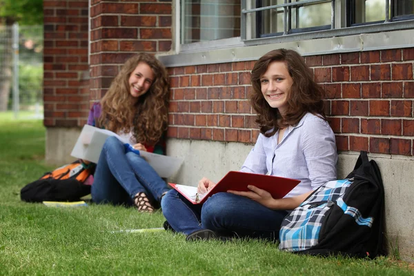 Estudante sente-se em uma grama — Fotografia de Stock