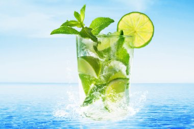 Glass of Mojito cocktail at the beach clipart