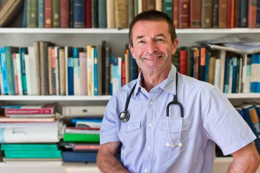 White Doctor In Front Of Books clipart