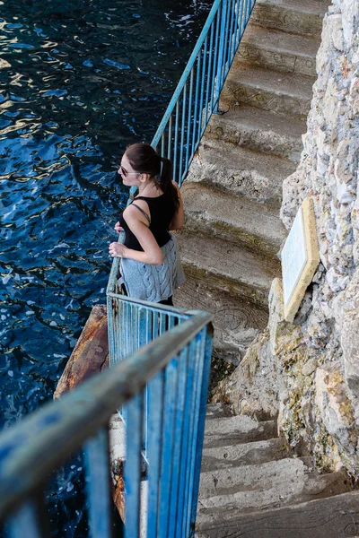 stock image Brunette Woman Standing At A Blue Railing