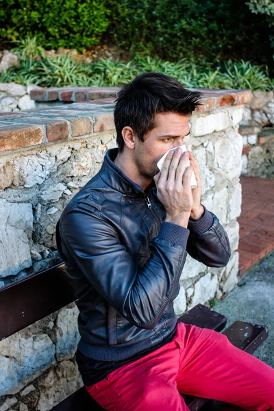 Attractive Brunette Man With Red Pants Blowing He's Nose — Stock Photo, Image