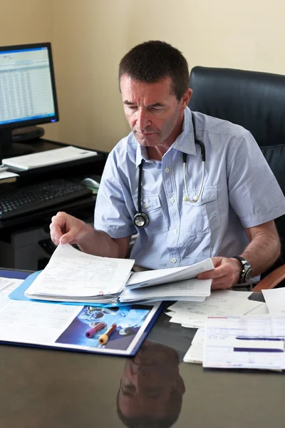 Doutor escrevendo em um documento — Fotografia de Stock
