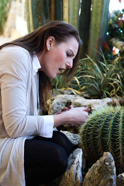 Woman pricked herself on a thorn from a cactus — Stock Photo, Image
