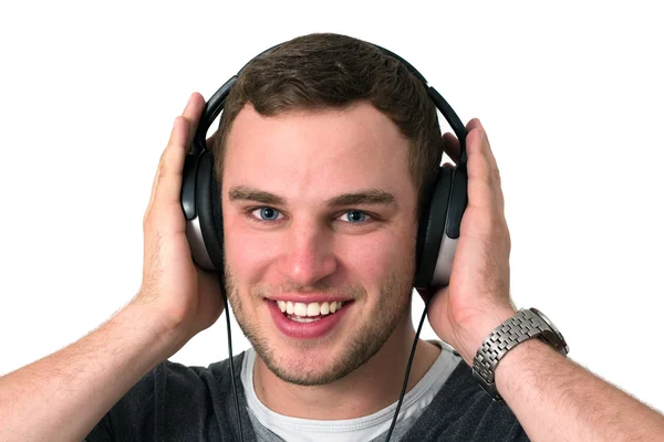 Primer plano de la cara del joven escuchando música — Foto de Stock