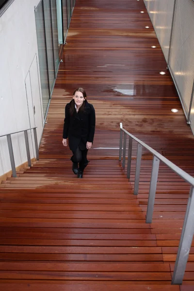 Brünette Frau geht Treppe hinauf — Stockfoto