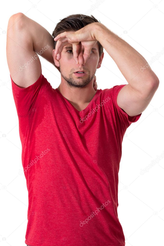 Man sweating very badly under armpit and holding nose