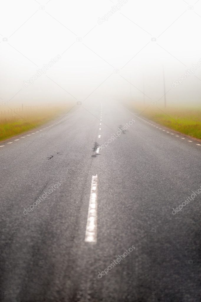 Asphalt road in fog