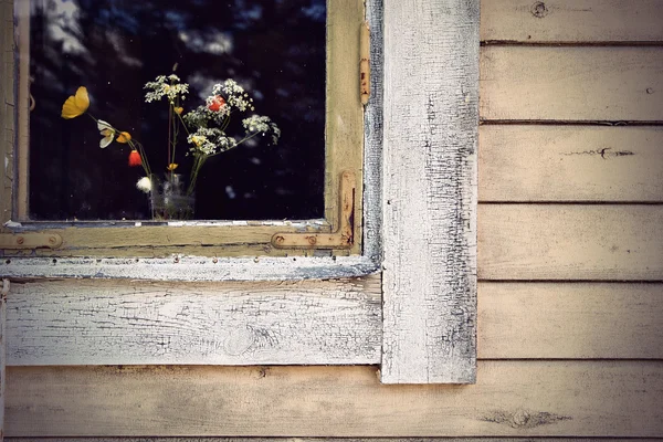Window with wild flowers — Stock Photo, Image