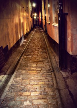 Narrow street in Stockholm at night clipart