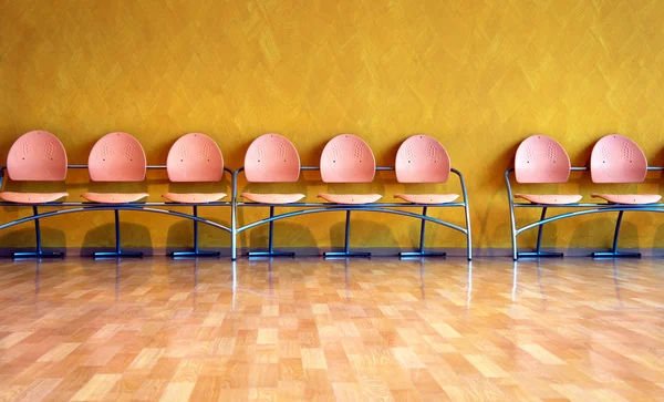 Empty pink plastic chairs — Stock Photo, Image