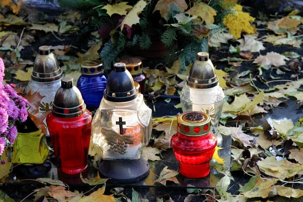 stock image Multicolor everburning candles on tomb in cemetery