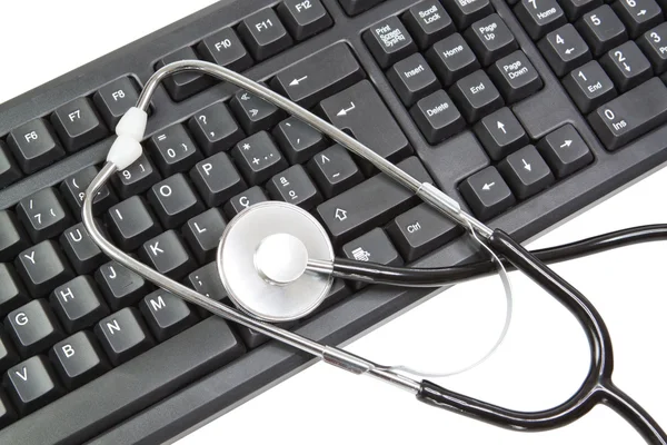 Keyboard for PC and elements for a stethoscope. On a white backg — Stock Photo, Image