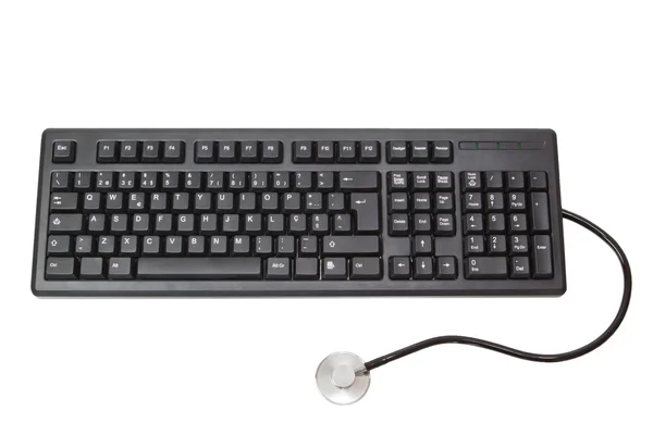 O teclado para o computador e o estetoscópio. em um branco est — Fotografia de Stock