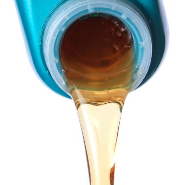 Flowing lubricating oil. Closeup. clipart
