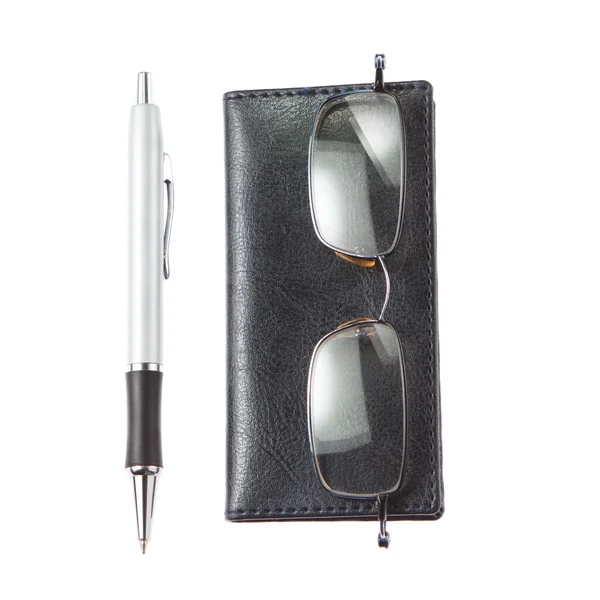 Glasses notebook pen tools accountant. Closeup on a white backgr — Stock Photo, Image