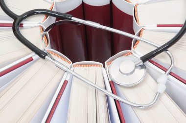 Set of encyclopedias, books and stethoscope closeup. clipart