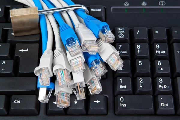 Blocked network cable on the background of the keyboard. — Stock Photo, Image