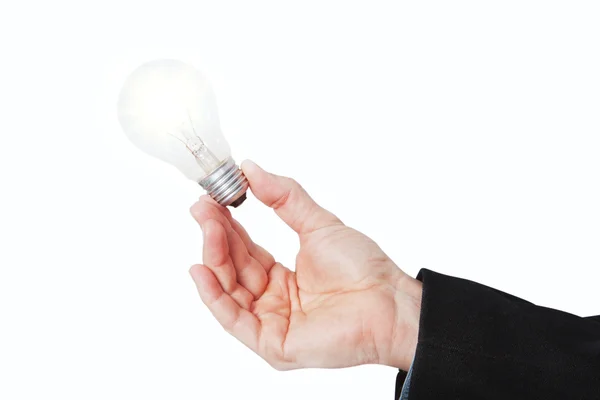 En upplyst lampa i handen. på en vit bakgrund. — Stockfoto