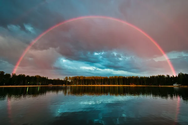 stock image Full rainbow over the lake