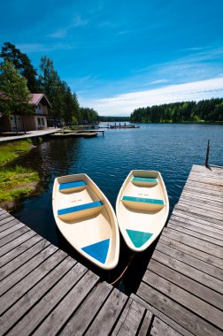 Two boats floating near pier clipart