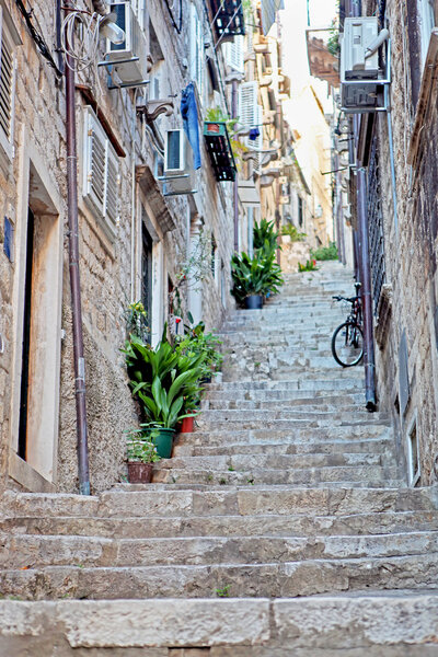 An old street with stairs,plants and modern air-conditioner in the Old City of Dubrovnik, Croatia.