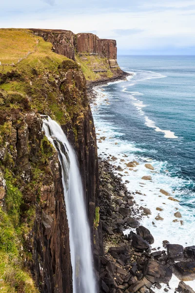 stock image Steep rocky coastline with water fall