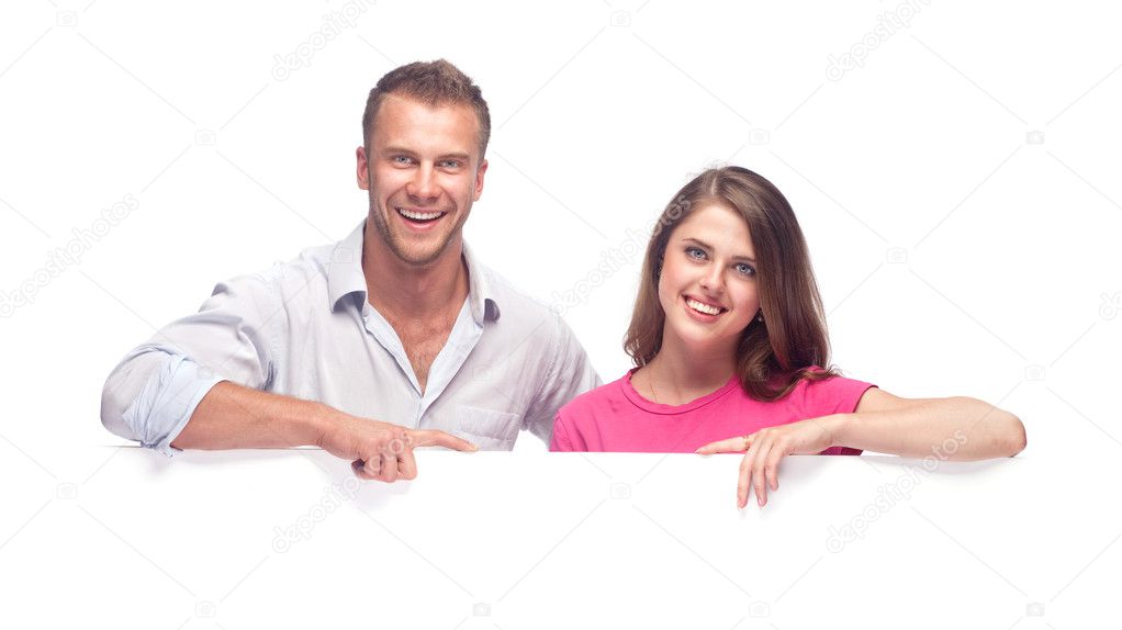 Portrait of a happy couple holding a blank billboard