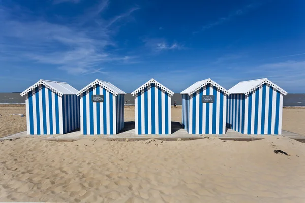 stock image White and blue striped beach house on a sunny beach in France