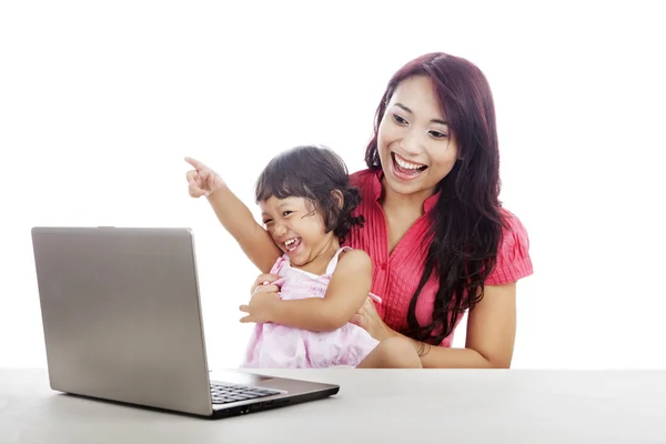 Happy mother and daughter with laptop — Stock Photo, Image
