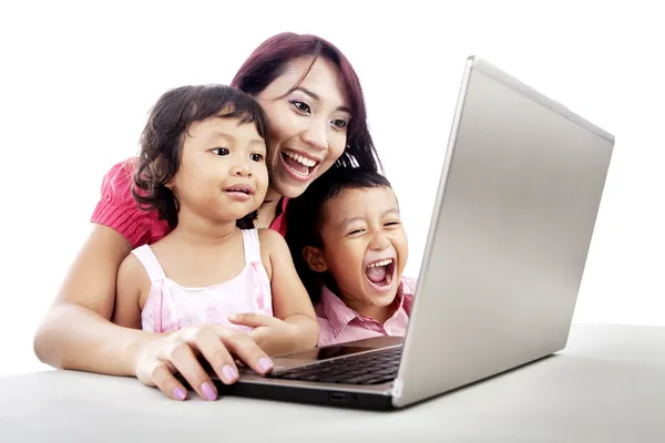 Happy family using laptop Stock Photo