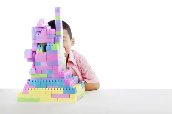 Парень прячется за блоками Лего — стоковое фото