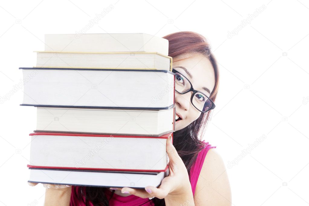 College student smiling behind books
