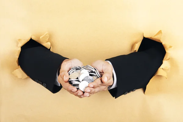Businessman's hands holding coins — Stock Photo, Image