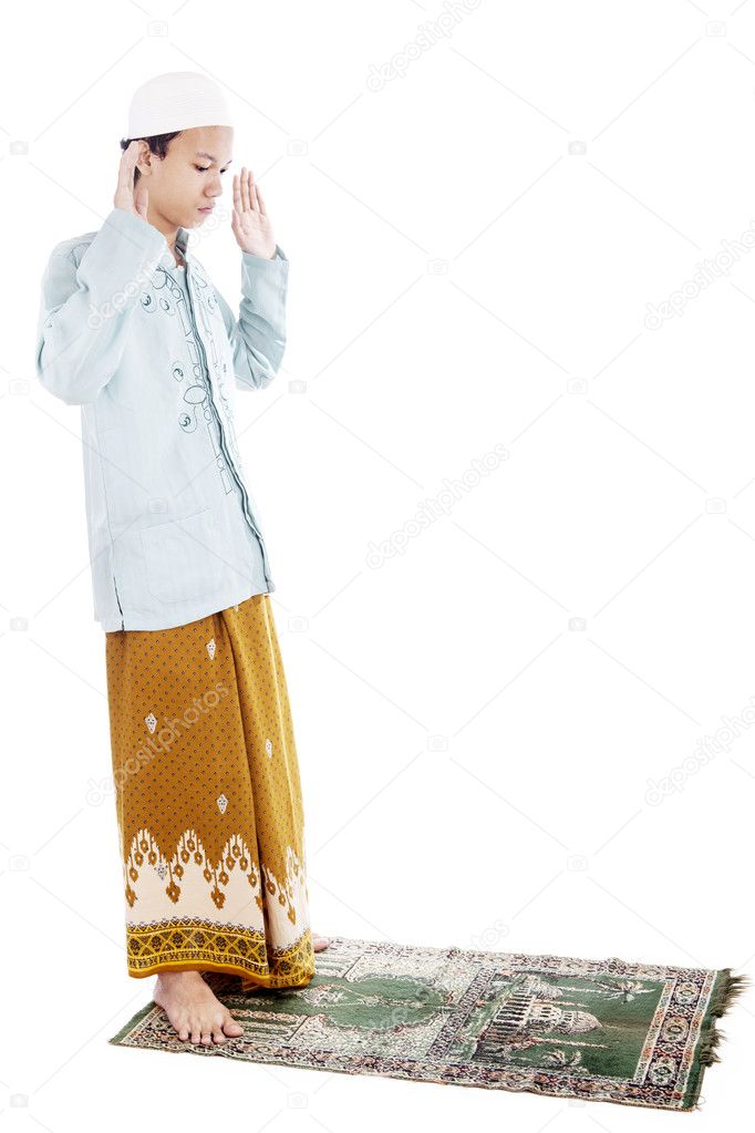 Muslim man praying on mat