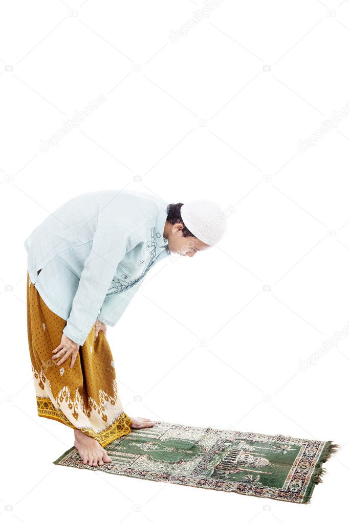 Muslim man bowing on prayer mat