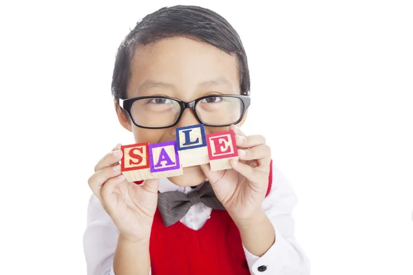 Schoolboy showing SALE word — Stock Photo, Image