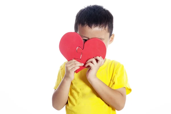 Chlapec s puzzle ve tvaru srdce — Stock fotografie