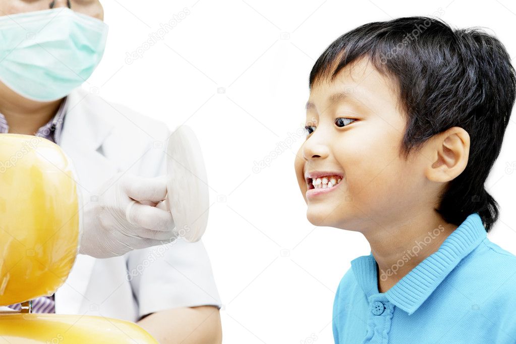 Child checking his teeth on mirror