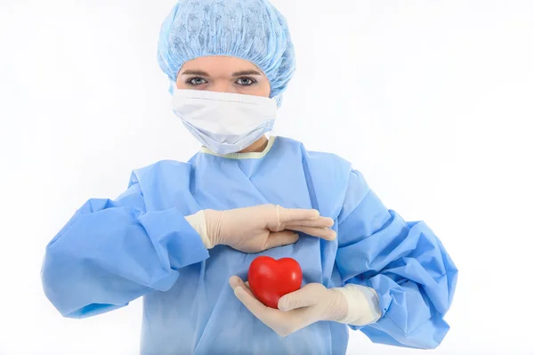 Female nurse holding a heart — Stock Photo, Image