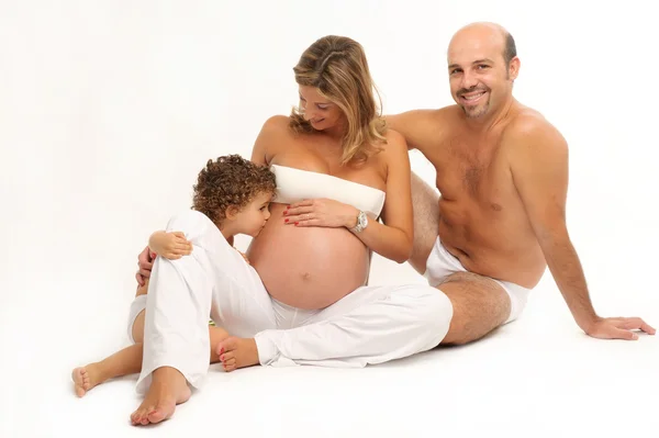 Familia feliz con una mujer embarazada y un niño —  Fotos de Stock