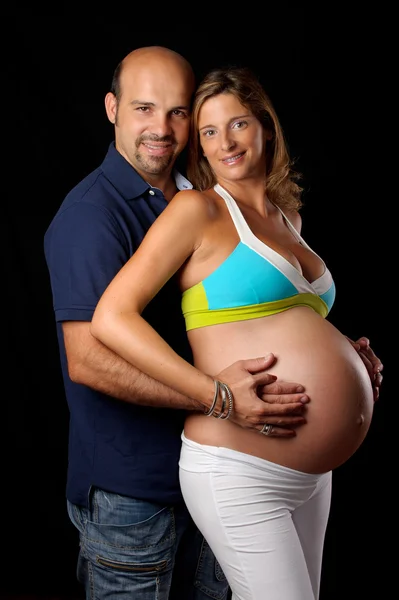 Pregnant woman and husband touching her belly — Stock Photo, Image