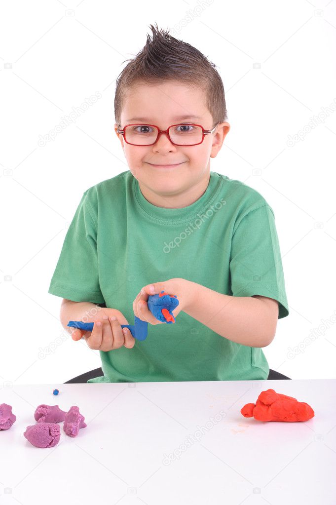 Young boy playing with modeling clay