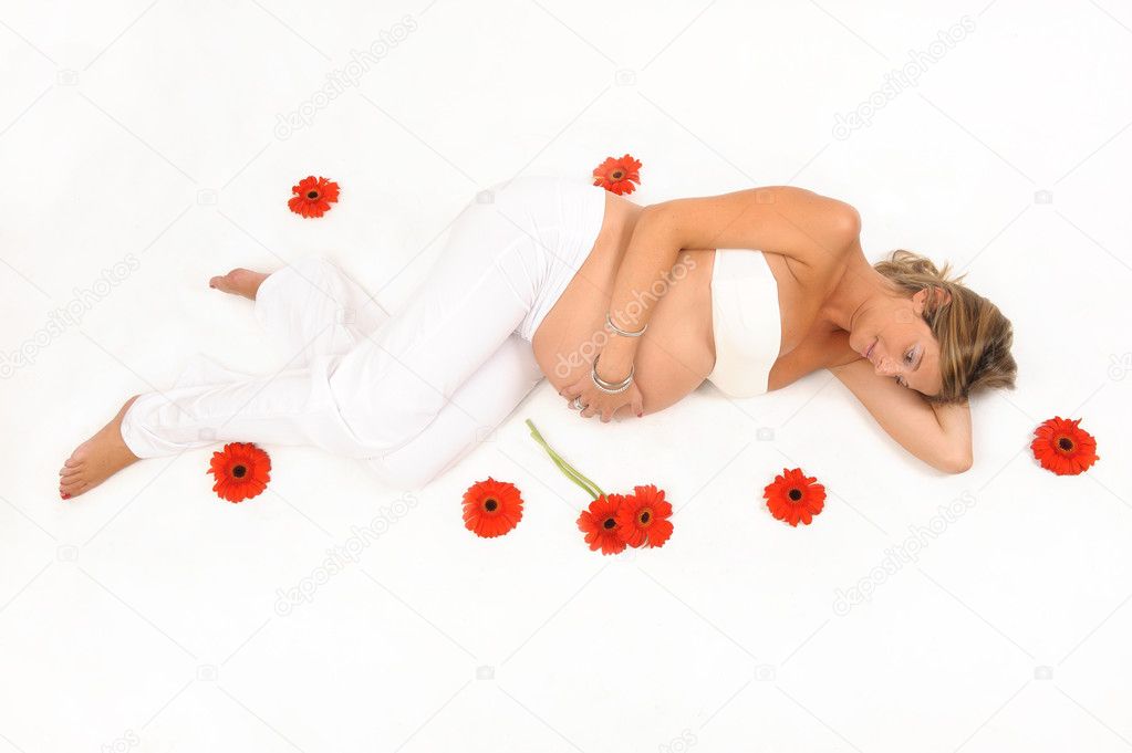 Pregnant woman surrounded by flowers