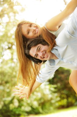 Young happy couple in the park clipart